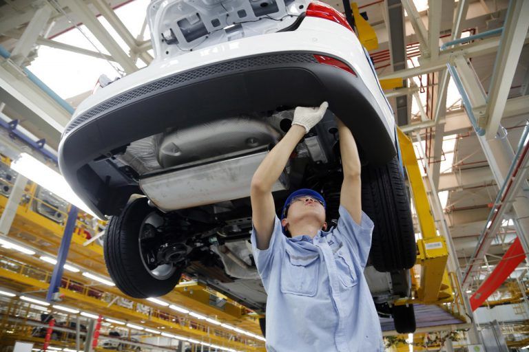 FILE - In this Tuesday, April 16, 2013, photo, a worker assembles a vehicle on an assembly line at Ford factory in Chongqing, China Tuesday, April 16, 2013. Ford Motor Co. reports quarterly financial results before the market opens on Wednesday, April 24, 2013. (AP Photo/File)