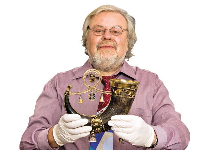 Museumsdirektor Siebenmorgen mit einer Greifenklaue, einem Trinkhorn.