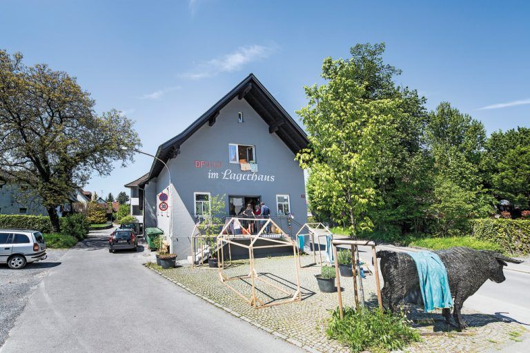 Erneuerter Außenraum Der Gestaltungsanspruch des DF-Shops im Lagerhaus wird selbstsicher in Beschriftung und Dekoration nach außen getragen und schließt den Außenraum mit ein. Unter der neu gepflanzten Buche auf dem Vorplatz sollen regelmäßig Veranstaltungen stattfinden.