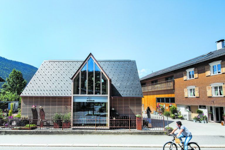 Der Quergiebel nimmt auf der Straßenseite das Schaufenster auf, auf der Rückseite das Treppenhaus. Das Schaufenster geht über beide Geschoße und gibt Einblick in die Innenräume, die wie eine gestaltete Auslage wirken.