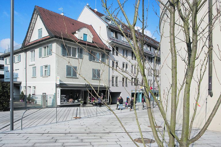 HELLER GRANIT akzentuiert mit dunklen Basaltstreifen setzt die Oberflächentextur des Marktplatzes in das Umfeld fort und lässt so die Stadtquartiere wie selbstverständlich zusammenwachsen.