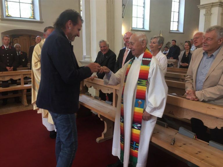 Bürgermeister Herbert Bitschnau steckte im Rahmen einer Messfeier den Ehrenring an Pfarrer Peter Bitschnaus Finger. <span class="copyright">Str</span>