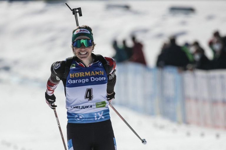 TOPSHOT - Austria's Lisa Theresa Hauser celebrates as she crosses the finish line to win the Women's 12,5 km Mass Start event at the IBU Biathlon World Championships in Pokljuka, Slovenia, on February 21, 2021. (Photo by Anze KACIN / AFP)