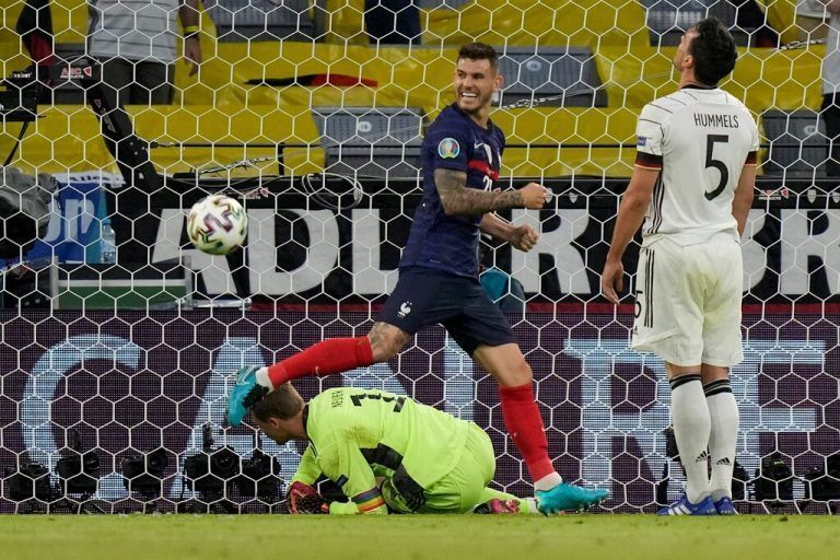 France's defender Lucas Hernandez (L) celebrates after his shot was deflected into the goal by Germany's defender Mats Hummels (R) during the UEFA EURO 2020 Group F football match between France and Germany at the Allianz Arena in Munich on June 15, 2021. (Photo by Matthias Schrader / POOL / AFP)