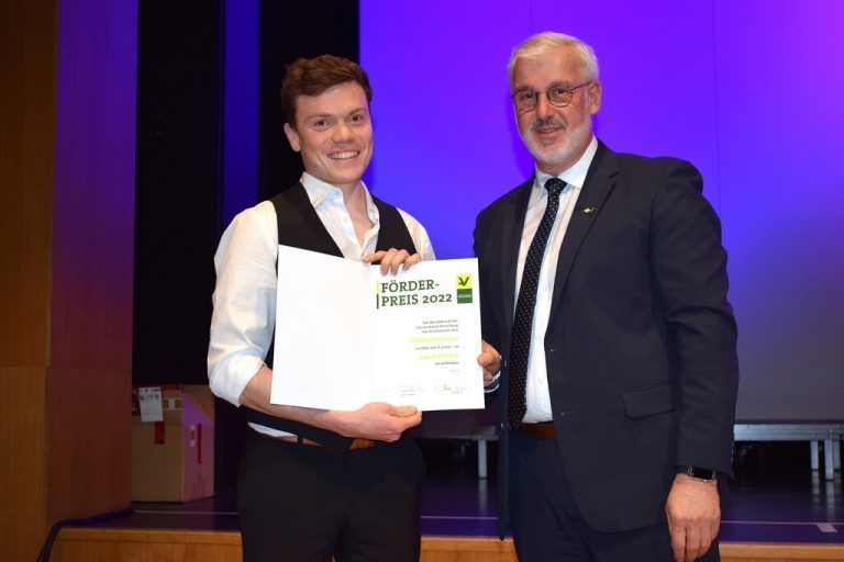 Chorverband-Obmann Axel Girardelli überreicht Jakob Peböck den Förderpreis 2022. CHORVERBAND