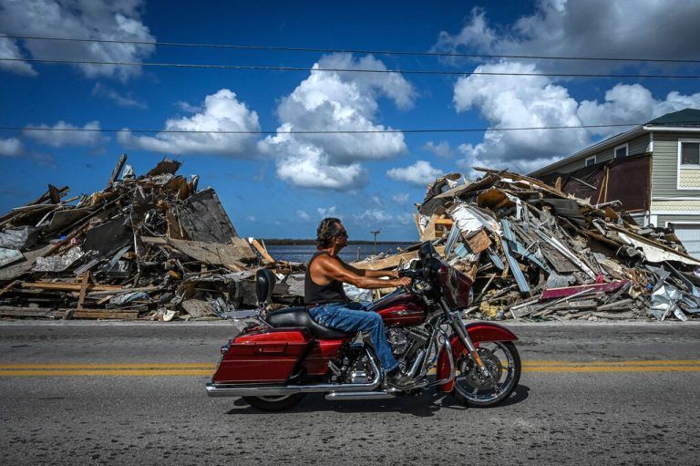 Auf Matlacha Island im US-Staat Florida kommt ein Motorradfahrer an Trümmern eines von Hurrikan 