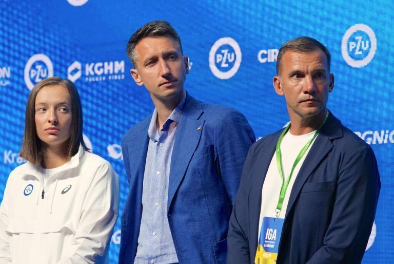 (L to R) Tennis world number one Iga Swiatek of Poland, retired Ukrainian tennis player Sergiy Stakhovsky and Ukrainian Champions League-winning football player Andriy Shevchenko attend a press conference ahead of the charity tennis event 