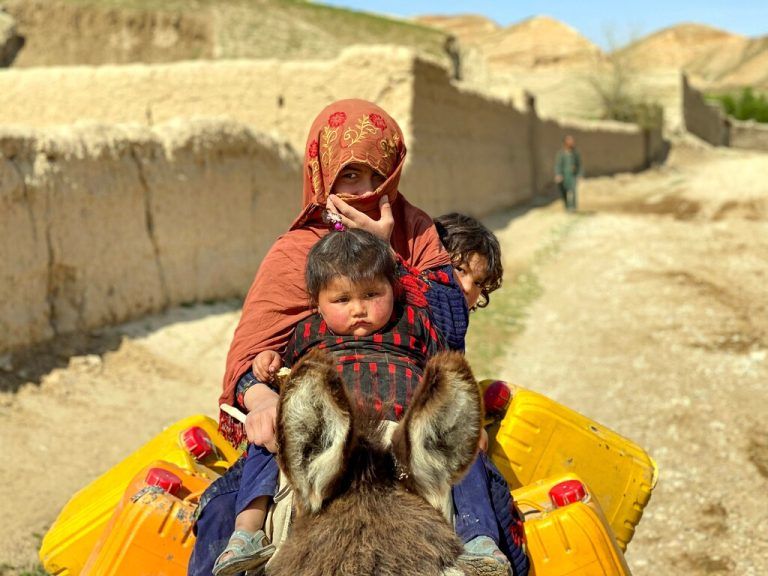 Eine afghanische Frau reitet mit ihren Kindern auf einem Esel durch eine Straße im Bezirk Zari in der Provinz Balkh. AFP