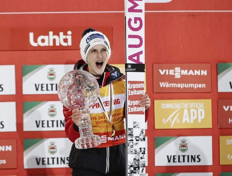 Eva Pinkelnig of Austria celebrates with the crystal globe after winning the women's ski jumping world cup season overall title during the FIS Nordic World Cup closing weekend event at the Lahti Ski games in Lahti, Finland, on March 24, 2023. - The Lahti Ski Games were organized for the first time in 1923 - a year before the first official Winter Olympics. (Photo by Antti Hämäläinen / Lehtikuva / AFP) / Finland OUT