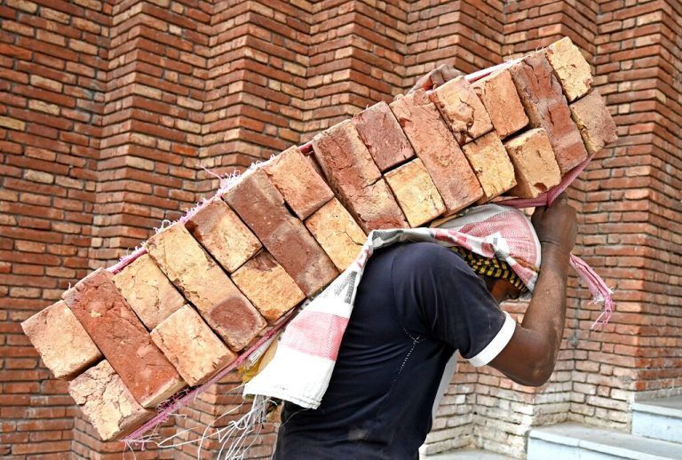 Knochenarbeit: Ein Arbeiter trägt Ziegelsteine auf einer Baustelle in Amritsar im nordindischen Bundesstaat Punjab. AFP