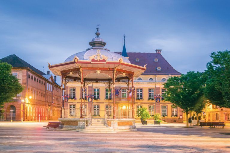 Der Marktplatz von Belfort ist bei Nacht schön beleuchtet. Tagsüber ist er ein Treffpunkt für viele Menschen. Shutterstock
