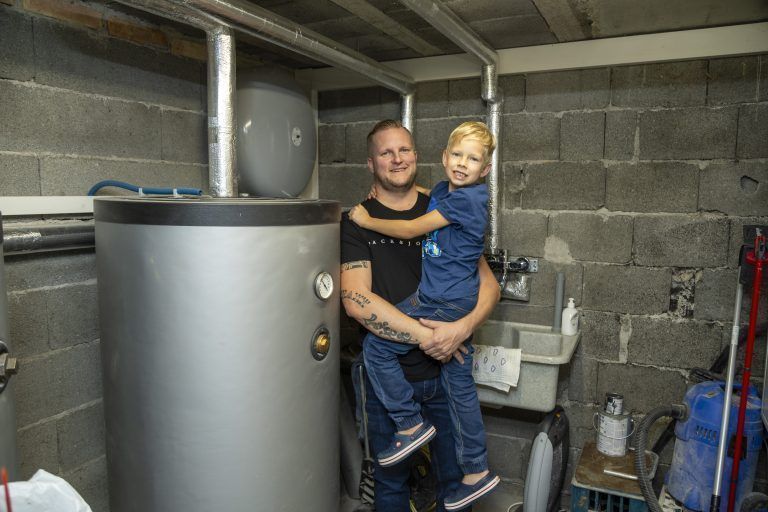 Philipp Wiedemann und Sohn Oscar im Heizungskeller vor dem Speicher.