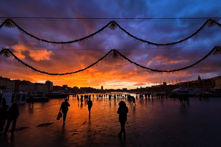 Menschen spazieren bei Sonnenuntergang in Marseille in Südfrankreich am Vieux-Port (dem Alten Hafen) entlang. AFP