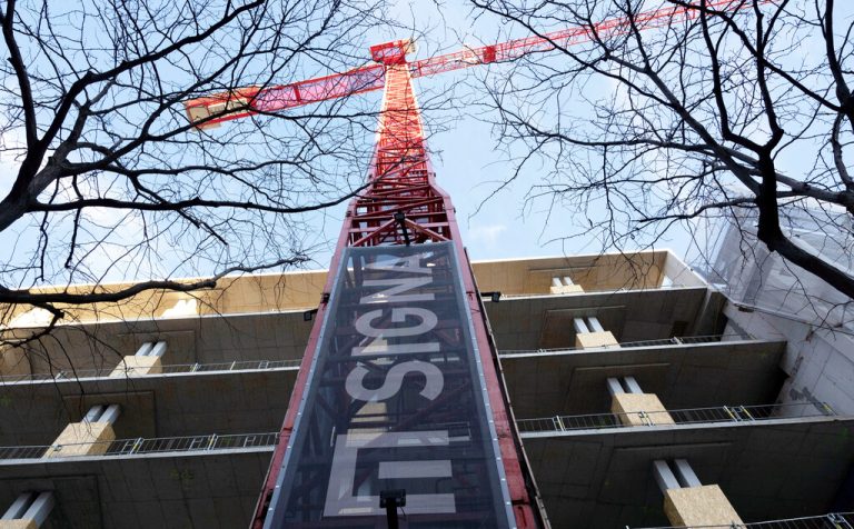 The sign of Signa Holding is placed on a crane next to a construction site in Vienna, Austria, December 19, 2023. REUTERS/Lisa Leutner
