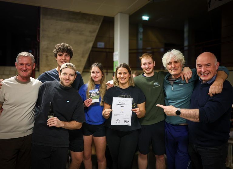 Direktor Ariel Lang (r.) und Sportlehrer Markus Flatz (l.) gratulieren dem Volleyball-Siegerteam bestehend aus ehemaligen Schülern und Lehrern.
