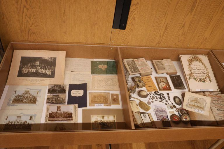 Neue Erkenntnisse zu historischem Dorfkern: Vitrine mit Fotos, Dokumenten und religiösen Gegenständen..