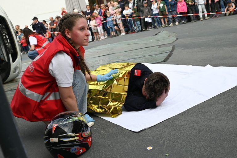 Beeindruckende Schauübung der Feuerwehr: Vorsichtig nahm diese Helferin den Helm des verunglückten Motorrad-Fahrers ab.
