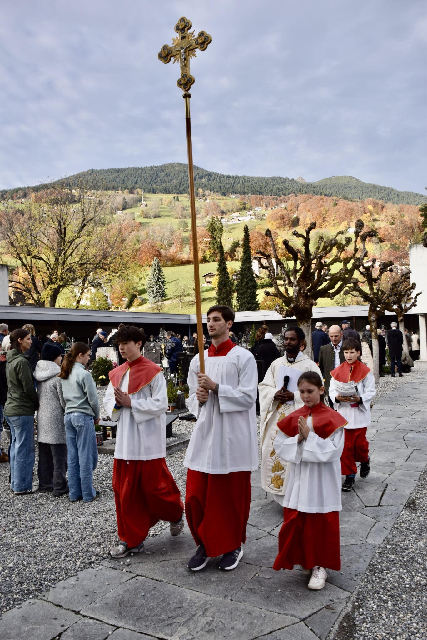 Kaplan Albert Joseph Jesuraj mit den Ministrierenden am Schrunser Friedhof, wo sie nach der Gräbersegnung um Spenden für das „Schwarze Kreuz - Kriegsgräberfürsorge“ baten.
