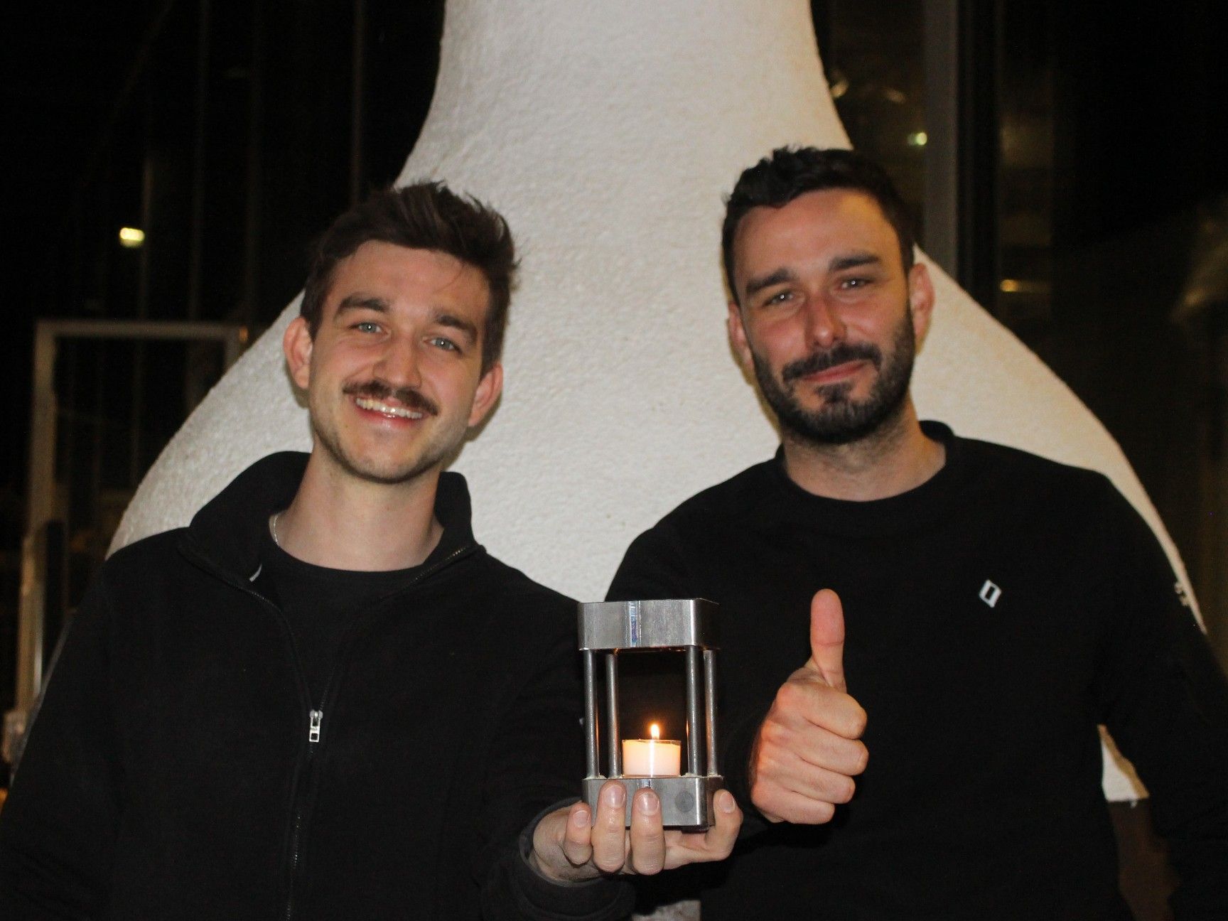 Ofenbauer Simon Voppichler und Sohn Tobias präsentieren den „Teelichtofen“, von dem fast 200 Stück hergestellt wurden. Im Hintergrund ein Ofen, der als Projekt der Werkraumschule gebaut wurde.
