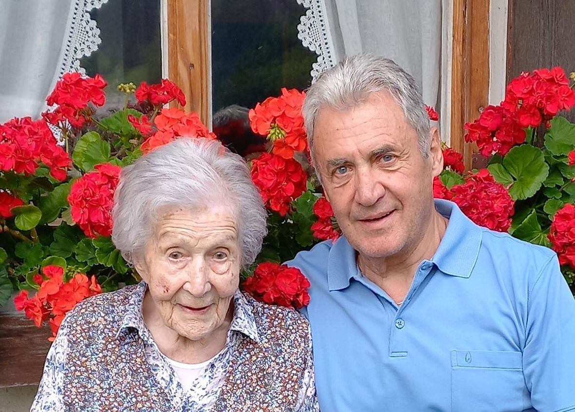 Mit Sohn Franz vor dem blumengeschmückten Haus.