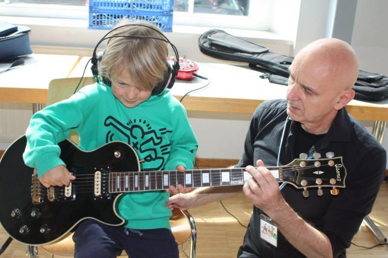 Günther Burger mit Tester Jakob beim Gitarre spielen üben. 