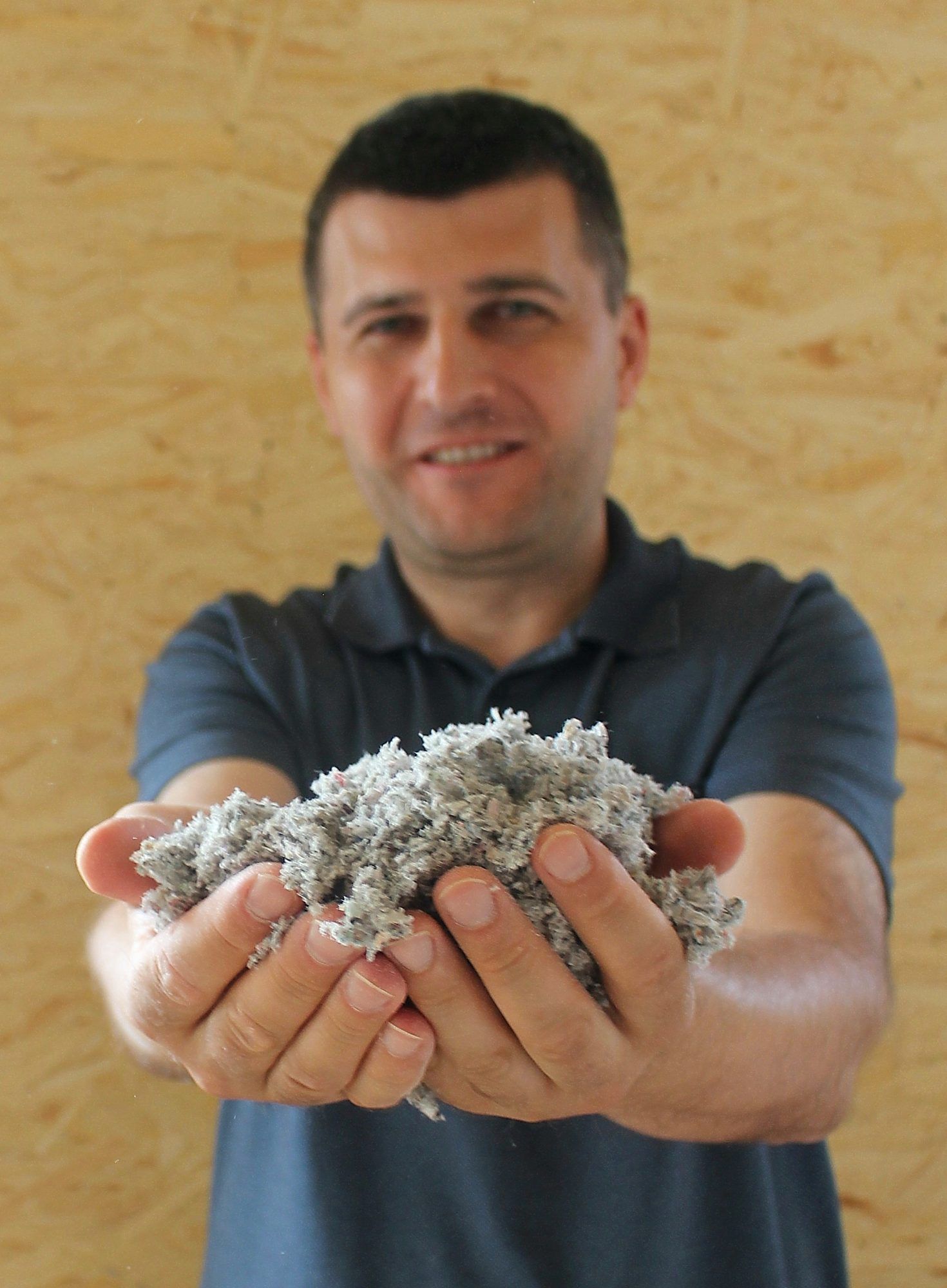 Projektleiter Mitar Simikic erläutert Nachhaltigkeit bei der Wärmedämmung: diese wird mit recyceltem Altpapier bewerkstelligt.